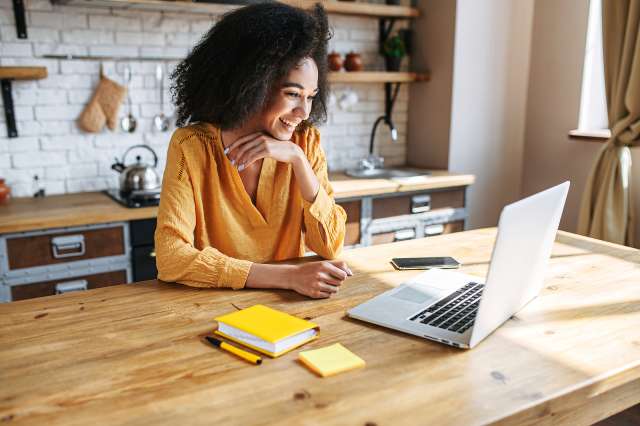 A woman uses a laptop. This relates to concepts of therapy in St. Louis, MO. Our therapist in St. Louis, MO have openings for therapy in St. Louis, MO.